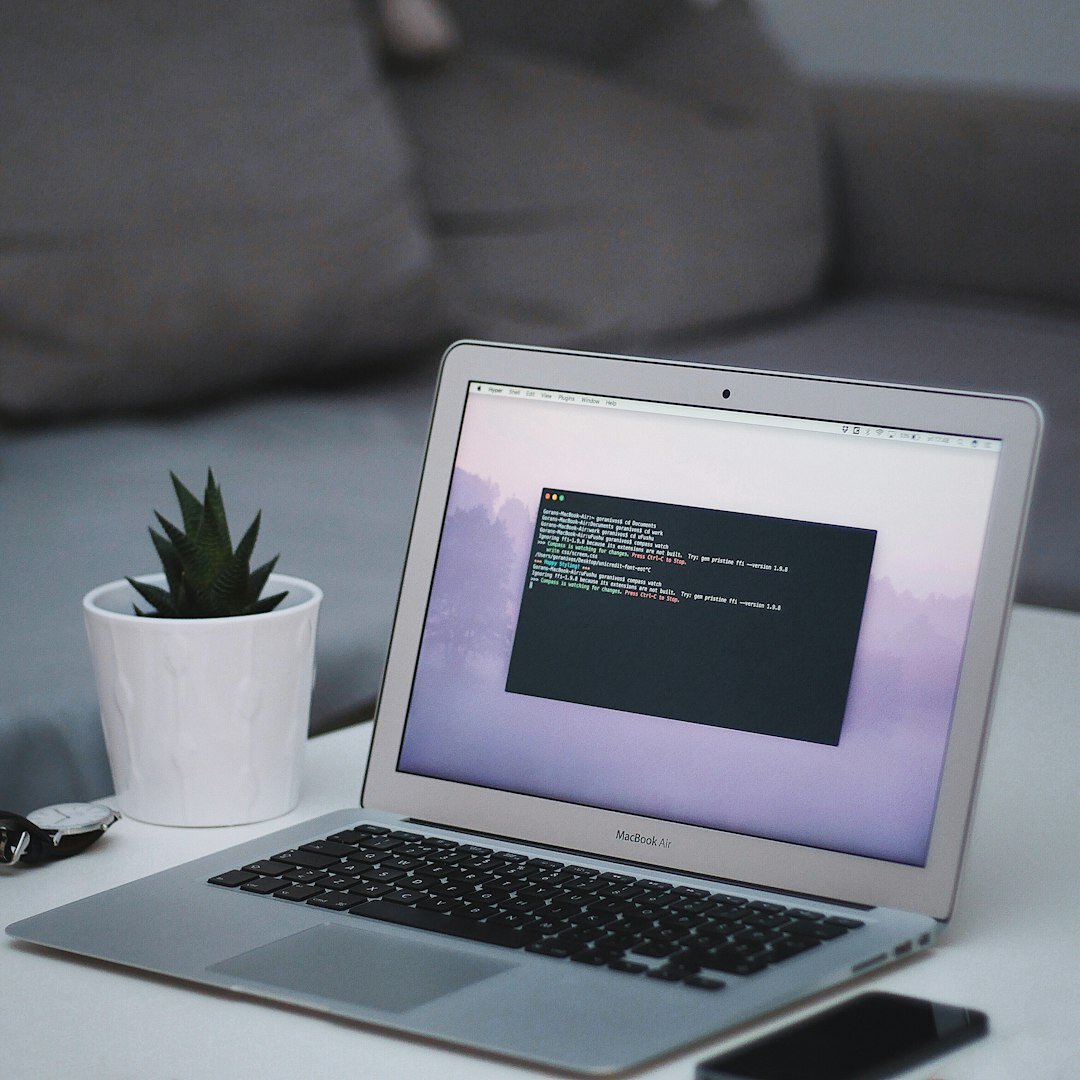 Sleek silver laptop with futuristic tech interface
